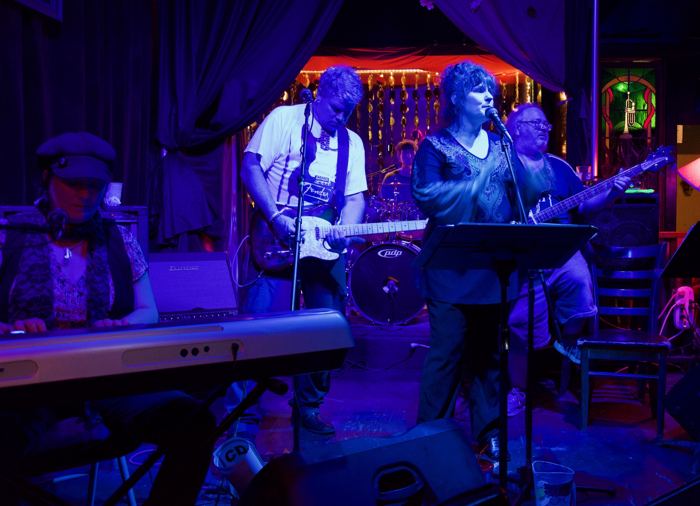 The band under blue stage lights