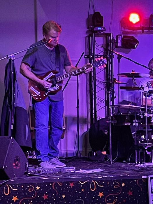 Guitar under purple lights